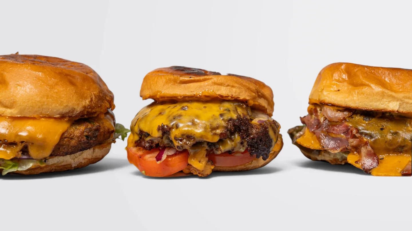 Three Gingerhead burgers photographed side by side on a light background